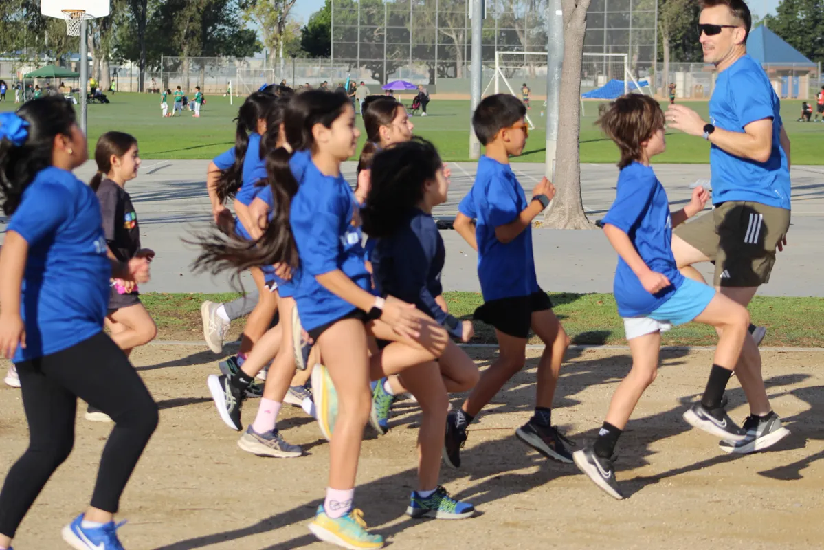 Youth runners warming up at practice
